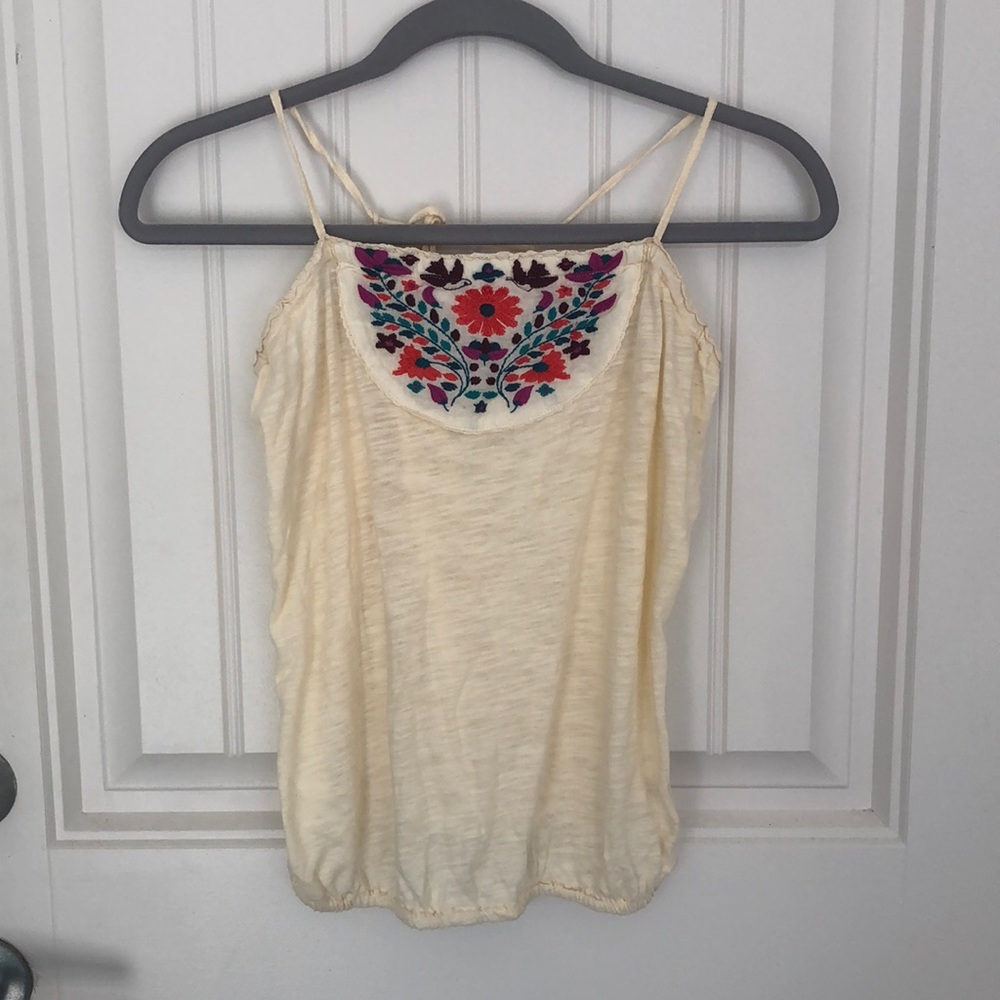 Cream colored sleeveless top with floral detail